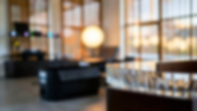 Blurred modern office interior bokeh background with warm morning lighting, ideal for professional virtual meeting backdrops or corporate presentation slides