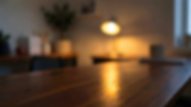 Blurred warm wooden table surface in cozy home office interior for product mockup background or website hero image