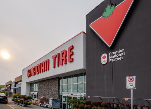 Calgary, Alberta, Canada. August 15, 2026. Exterior store sign for Canadian Tire retail warehouse location on hazy afternoon.