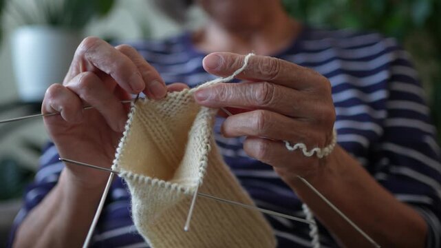 Close up of senior woman's hands knitting