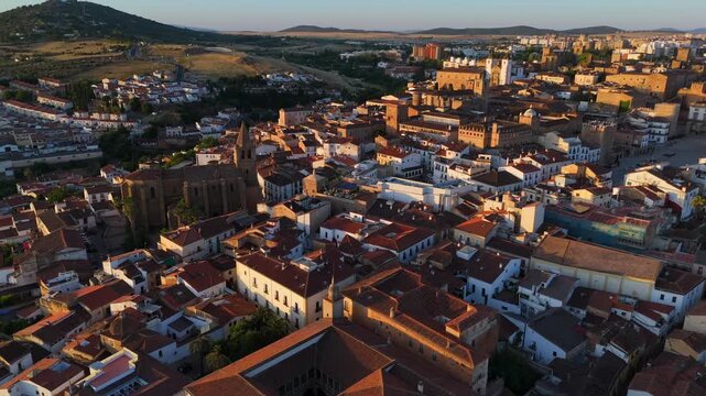 Historic churches, stone palaces and red tiled rooftops of C&aacute;ceres at sunrise