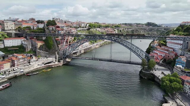 Porto city skyline and Dom Lu&iacute;s i bridge over the Douro river Portugal aerial drone shot of urban architecture and infrastructure cityscape