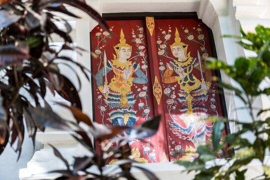 Traditional Lanna Guardian Mural Painting on Historic Temple Window at Wat Umong Chiang Mai Thailand
