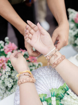 Traditional Thai Wedding Wrist Blessing Ceremony with Gold Bracelets