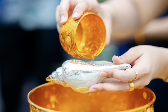 Traditional Thai Wedding Water Blessing Ritual with Sacred Conch Shell and Golden Bowl