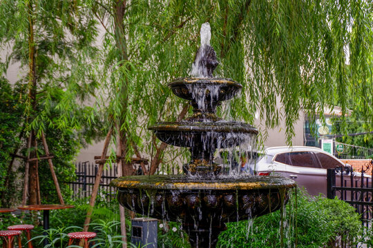 Luxury Fountain at green garden in house outdoor garden,Scenic View of a Beautiful English Style Landscape Garden in summer,selective focus.