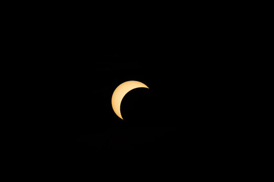 Berlin, Germany - 12 August 2026: View of a partial solar eclipse visible in the dark sky.