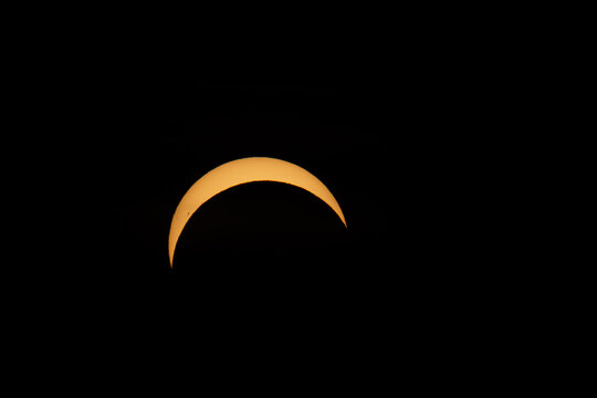 Berlin, Germany - 12 August 2026: View of a partial solar eclipse visible in the dark night sky.