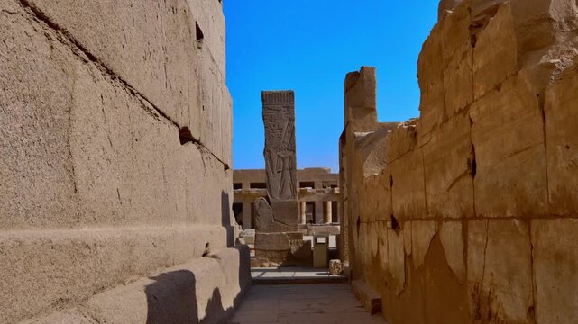 Karnak Temple in Luxor, Egypt. Massive hieroglyphic columns in Great Hypostyle Hall, Karnak Temple Luxor Egypt. Upward view of ancient carved pillars against blue sky.