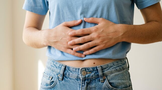 Person suffering from stomach pain or digestive issues, close up on torso