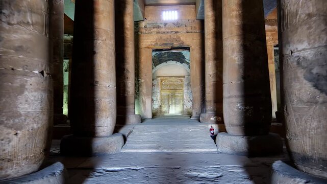 Ancient hall of the Abydos Temple with towering columns and intricate hieroglyphs, showcasing the spiritual depth and architectural mastery of Ancient Egypt.