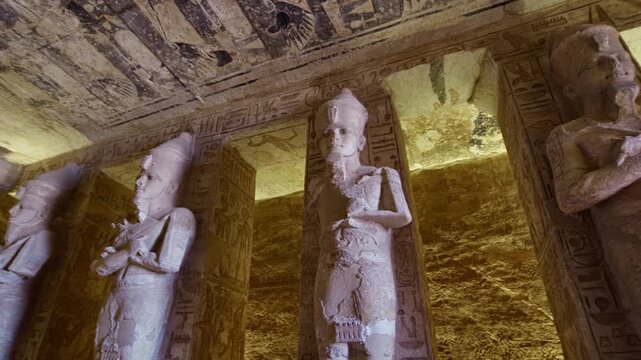 Ancient Egyptian chamber with statues and decorated ceiling inside the Abu Simbel Temple, showcasing sacred architecture, carvings, and timeless spiritual symbolism. Egypt.