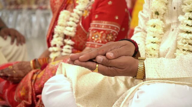 Indian man & Woman worshiping during pooja or ritual celebration