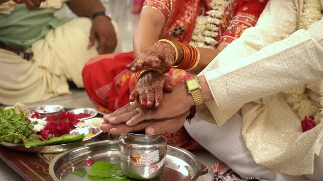 Indian Couple Praying  & celebrating indian ritual offering flowers and water 