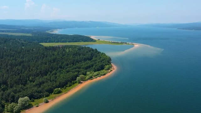 Shiroka Polyana dam reservoir pine forest shoreline Rhodope mountains aerial drone view pristine blue water mountain lake scenic nature landscape travel Bulgaria