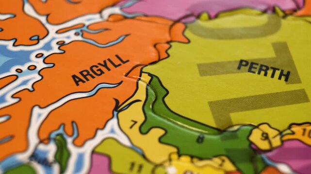 Scotland Puzzle Map with Scottish Cities Perth, Dundee, Aberdeen, Islay. Close-Up Video Background, Dolly Camera Move From Left to Right.. Selective focus.