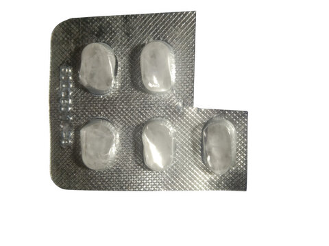 Five white pills in a silver foil blister pack for medication and health care isolated on transparent background