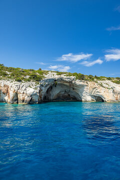 Spectacular blue sea cave Mediterranean natural rock arch crystal turquoise water Greece summer. Dramatic coastal nature seascape landscape. Sunny sky island adventure exploration geology wonder