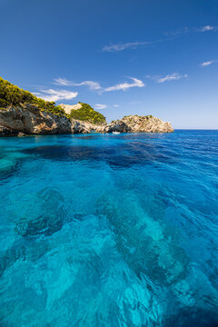 Serene blue cove crystal clear water limestone cliffs rocky coast summer shore. Beautiful coastal nature seascape landscape. Scenic Mediterranean destination azure sea, idyllic travel escape 