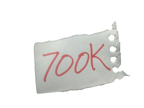 Small torn piece of paper with the handwritten red text 700k isolated on transparent background