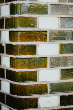 Close up of textured glass tile wall with green and white colors