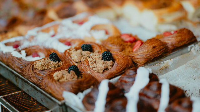 Delicious assorted pastries with berries and cream