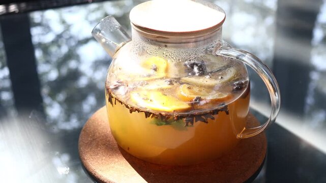 A refreshing pitcher of lemonade sits on a table, perfect for a backyard BBQ or outdoor gathering