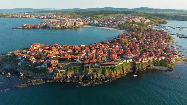 Sozopol old town peninsula aerial drone view ancient coastal fortress Black Sea rocky shores sunset golden hour light summer travel destination Bulgaria