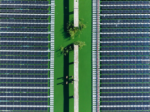 Aerial view of the floating solar power plant at Sloka wastewater treatment plant, featuring rows of solar panels on pontoons over green water in Jurmala, Latvia.