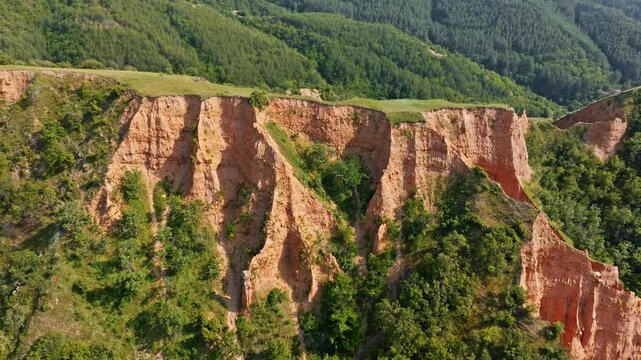 Stob Pyramids natural rock formations aerial drone view red clay sandstone cliffs green mountain forest landscape sunny day summer travel landmark Bulgaria