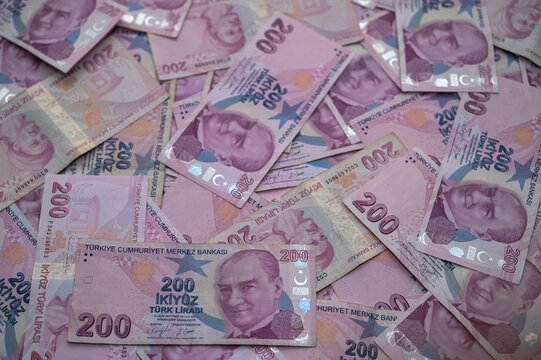 Colorful Turkish banknotes scattered across a vibrant surface create of currency