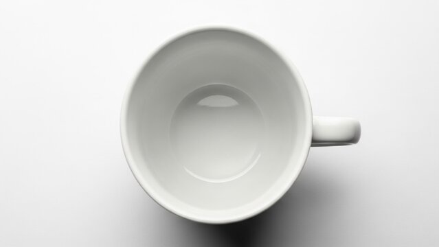 Top down view of a clean empty white ceramic coffee cup