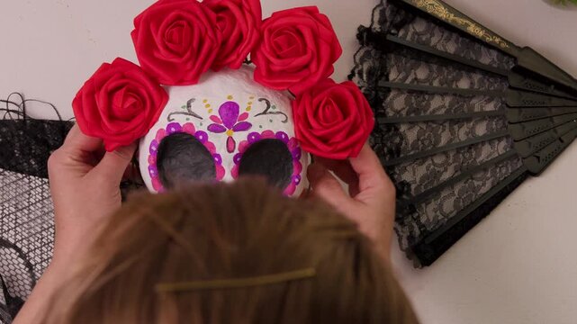 Handmade papermache calavera skull with red rose crown in Day of the Dead style