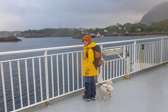 People, enjoying ferry ride between Bodo and Lofoten Moskenesoya summertime, child and adults on a ferry on sunset