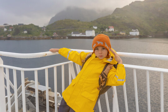 People, enjoying ferry ride between Bodo and Lofoten Moskenesoya summertime, child and adults on a ferry on sunset