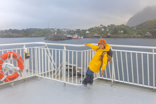 People, enjoying ferry ride between Bodo and Lofoten Moskenesoya summertime, child and adults on a ferry on sunset