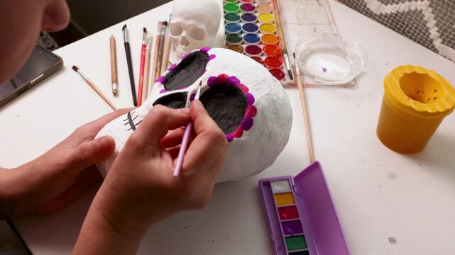Handmade papier mache skull in progress with Dia de los Muertos style detail painting
