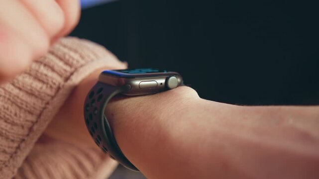 Close-up wrist with smartwatch as index finger presses watch edge near button, capturing subtle touch, slight wrist tilt, soft indoor lighting and clean modern wearable detail, with smartwatch, wrist