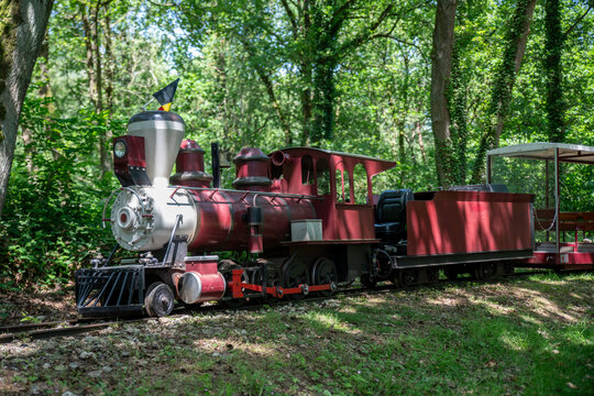 Red Miniature Steam Train And Passenger Car in Asch in belgium At Outdoor Park