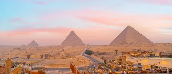 Panoramic view of ancient pyramids rising above a desert landscape at sunset in Cairo © f11photo