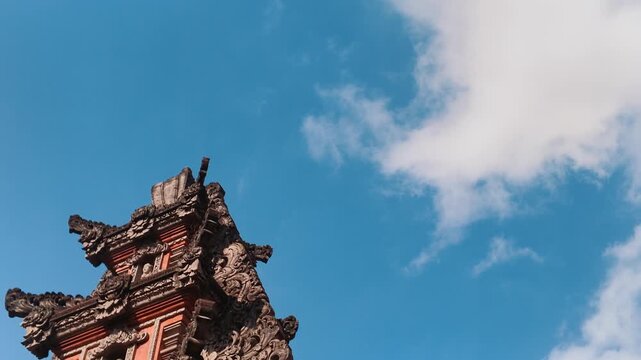 Traditional Balinese Temple Gate Architecture Against Blue Sky with Clouds