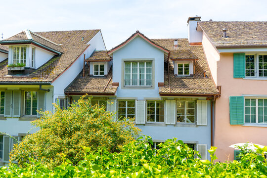 European Houses with Tiled Roofs, Dormer Window and Lush Green. Old city architecture. Cityscape in Zurich Switzerland