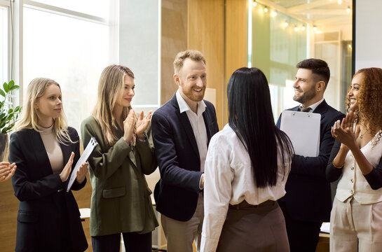 Team business handshake at meeting shows partnership. Colleagues applaud a new deal in a bright office, highlighting trust and leadership. Concept shows agreement and collaboration success.