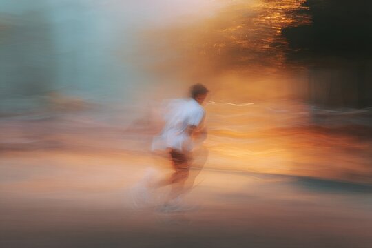 Motion blur runner in abstract warm light for dynamic background poster and banner design conveying speed and movement