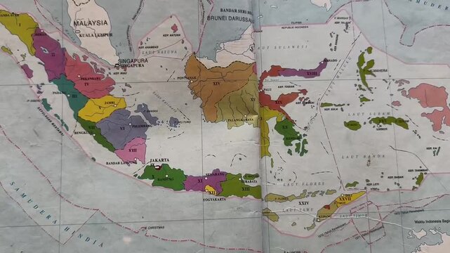 Close up video of printed political map of Indonesia archipelago printed in atlas