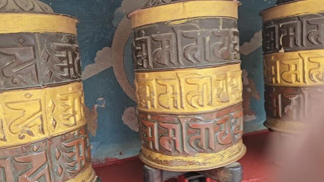 Tibetan Buddhist Prayer Wheels with Traditional Mantra Inscriptions in Temple, Spiritual Religious Symbolism 4K Stock Footage