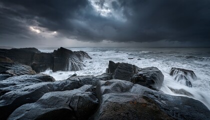 Fototapeta premium a dark stormy seascape featuring a shoreline with unique rock formations