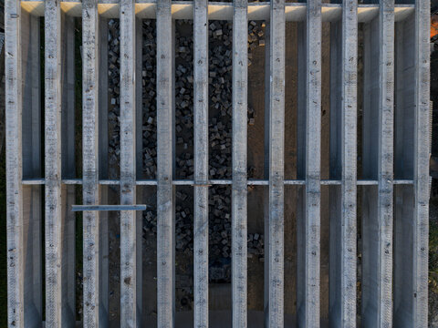Aerial view of concrete bridge girders for the Solo-Yogyakarta Toll Road construction, showing parallel beams and materials below in Kecamatan Depok, Daerah Istimewa Yogya, Indonesia.