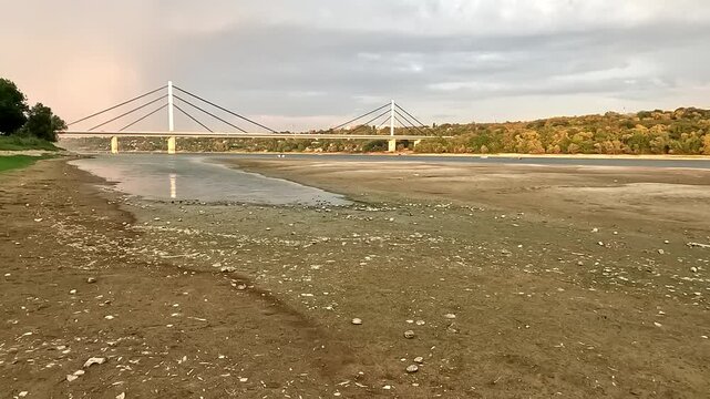 Low river water level on the Danube with suspended cargo ship navigation due to severe hydrological drought and climate change.