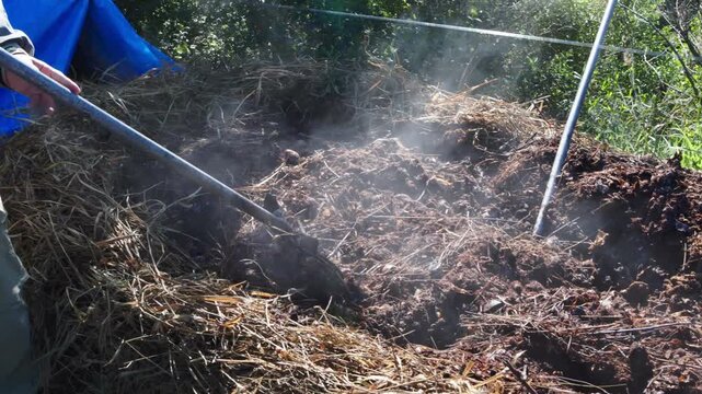 Turning organic waste windrow for aerobic decomposition at composting facility